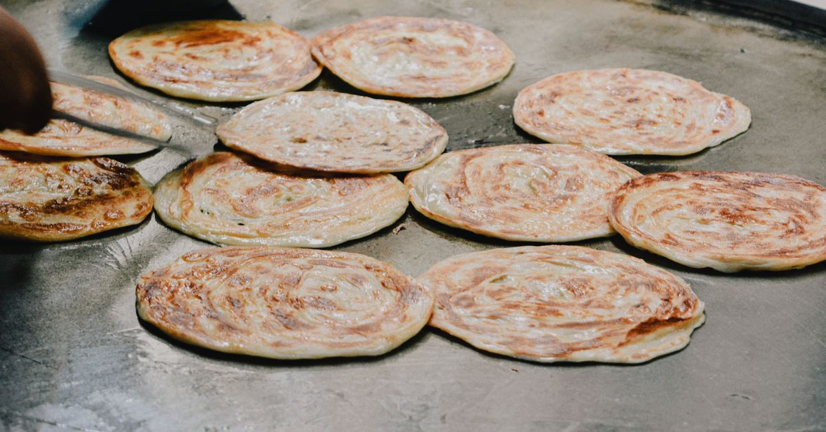 Discover roti canai, a flaky and golden Malaysian flatbread, delicious served with curry. An easy recipe to enjoy at home.