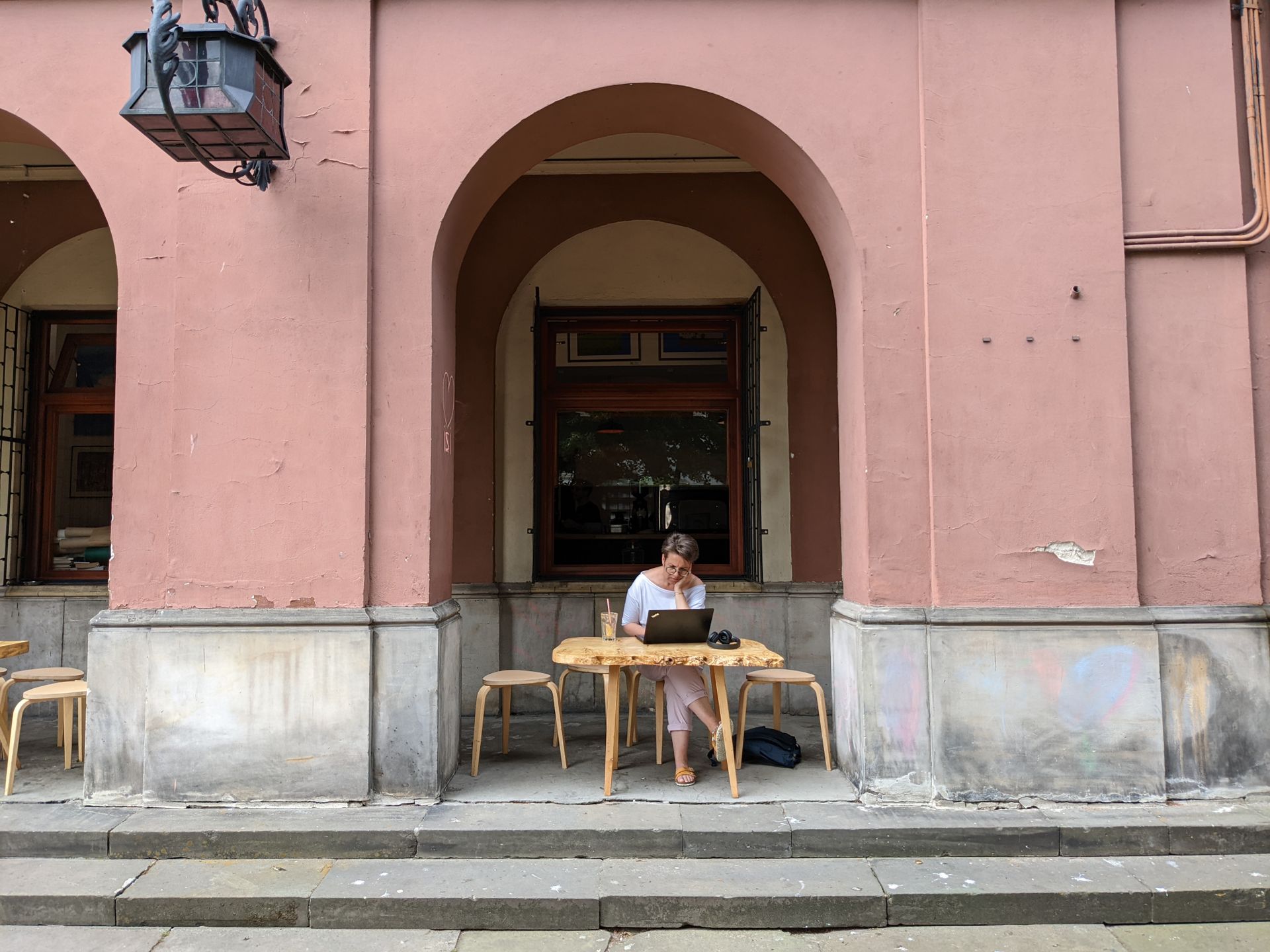 Nomad working on a laptop on a café terrace